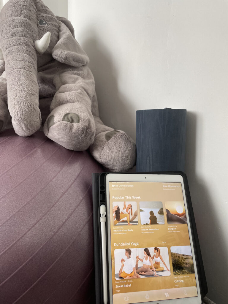 Bloom App on ipad with yoga ball and mat